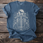 Blue t-shirt with viking-themed graphic of wolves, raven, and ornate gateway under moon.