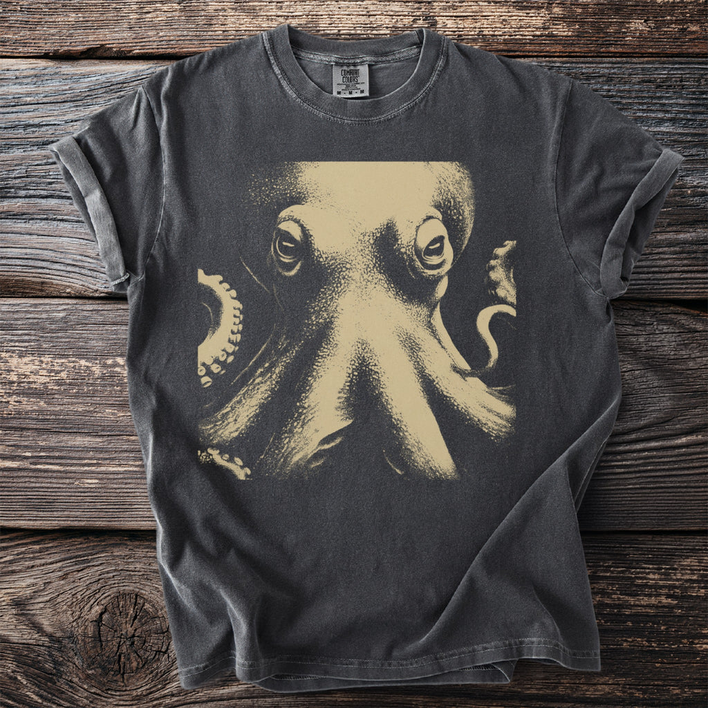Graphic t-shirt with a close-up etching of an octopus on a dark background.