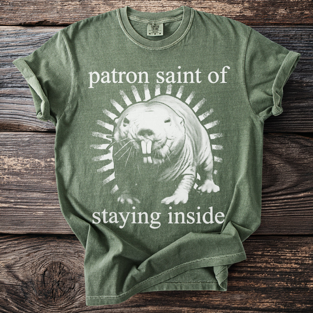 Green t-shirt with graphic of a mole rat and text "patron saint of staying inside."