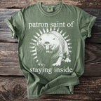 Green t-shirt with graphic of a mole rat and text "patron saint of staying inside."