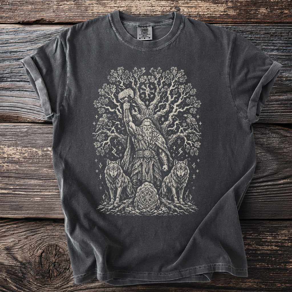 Dark t-shirt with Viking imagery: Odin holding Thor's hammer, wolves, ravens, and a tree.