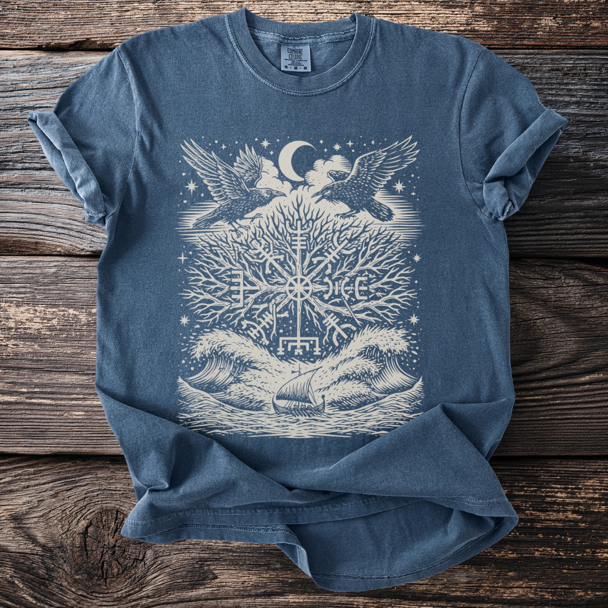 Blue t-shirt with a central graphic of a Viking compass, ravens, and a ship.