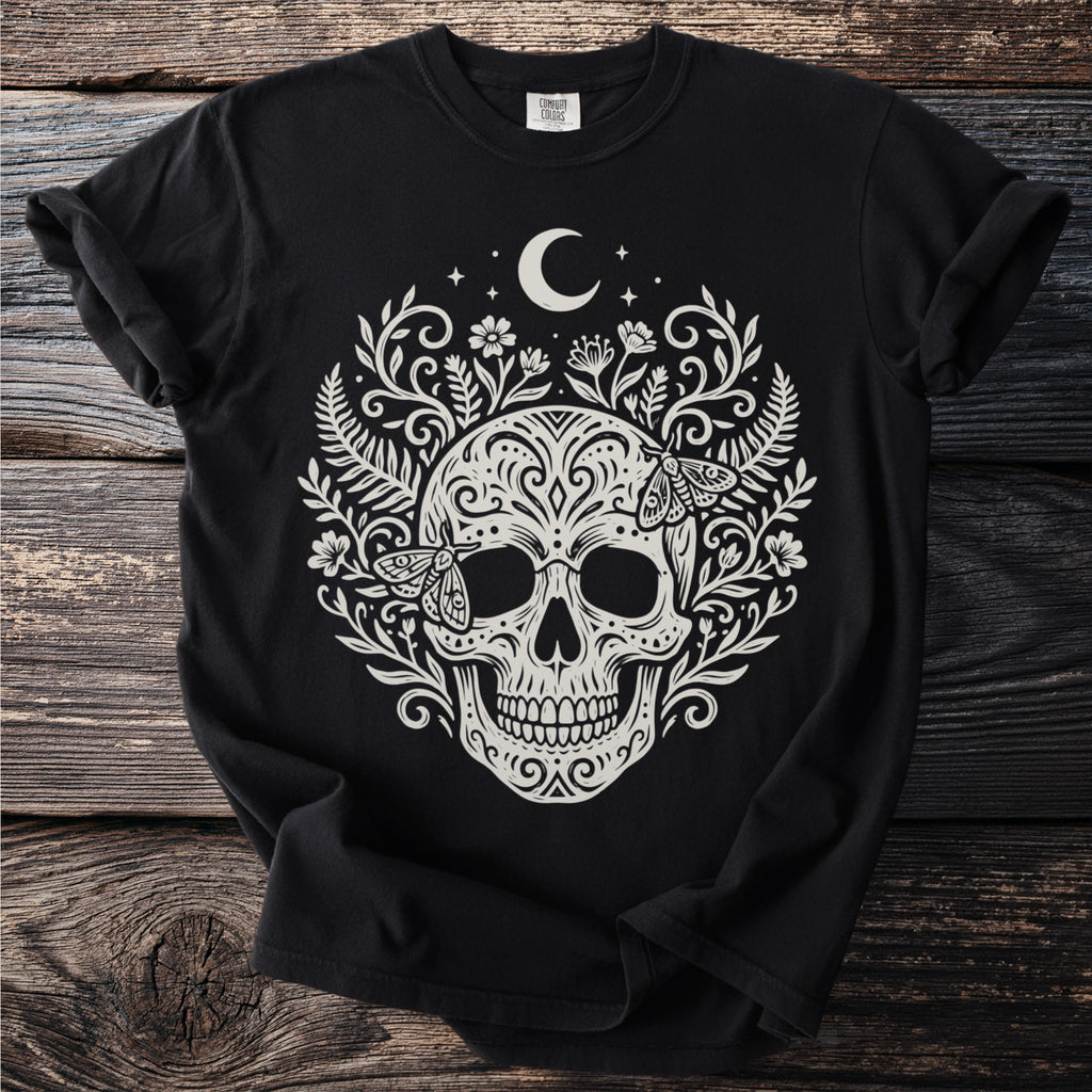 Black t-shirt with a cream-colored skull, moon, moths, and floral design.