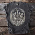 Dark grey t-shirt with a circular cream design of figures dancing around a bonfire under a moon.