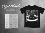 Black t-shirt with "do not perceive me" text and cat in sink graphic, size chart listed.
