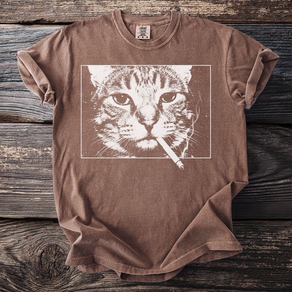 Brown t-shirt with a white graphic of a cat smoking a cigarette.