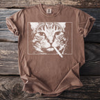 Brown t-shirt with a white graphic of a cat smoking a cigarette.