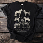 Black t-shirt with a vintage-style illustration of six horse breeds titled "The Steed Cabinet".