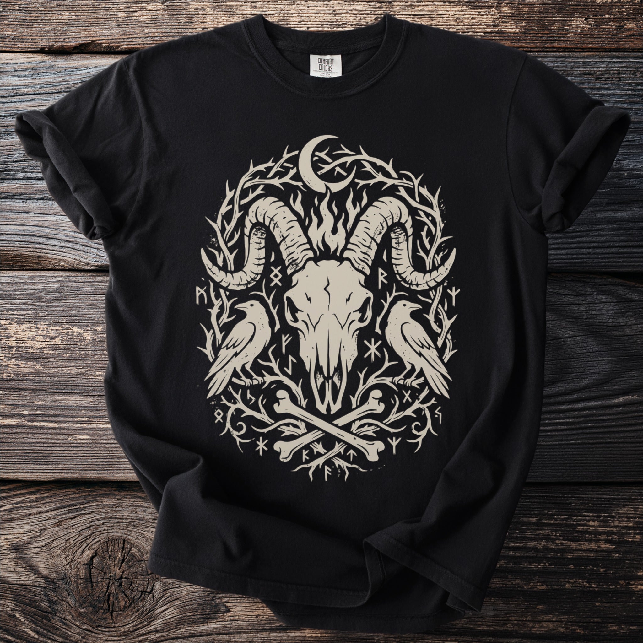 Black t-shirt with a beige occult graphic featuring a ram skull, ravens, and thorny branches.