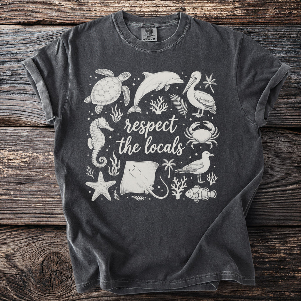 Dark t-shirt with white line art of sea creatures and text "respect the locals".