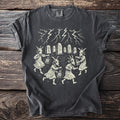 Dark gray t-shirt with a graphic of figures in goat masks holding lanterns, a stone circle, and lightning.