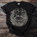 Black t-shirt featuring a circular forest scene with moon, mushrooms, fairies, and moths.