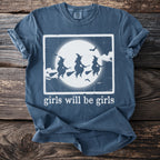 T-shirt with three witches flying on broomsticks in front of a full moon.