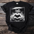 Black t-shirt with a scarecrow graphic forming a heart with its hands.