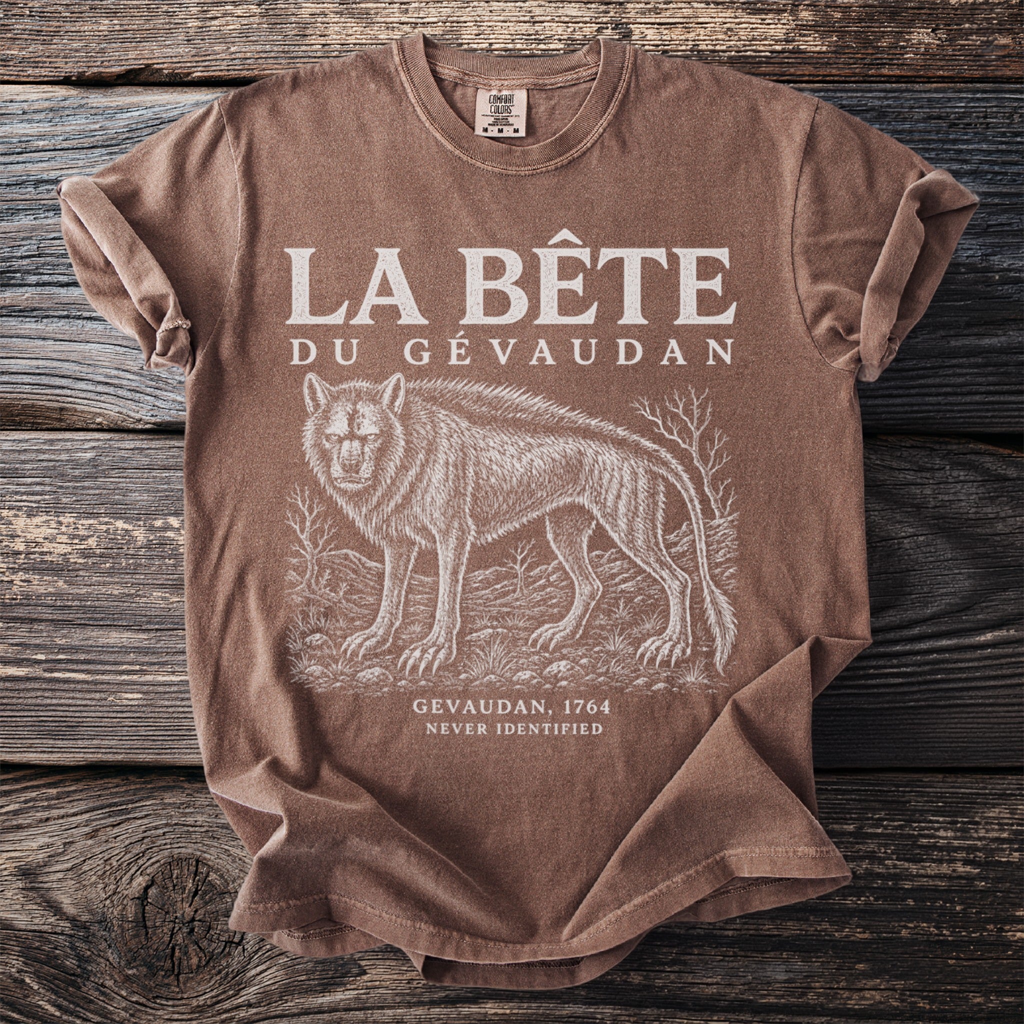 Brown t-shirt with "LA BÊTE DU GÉVAUDAN" text and a wolf illustration.