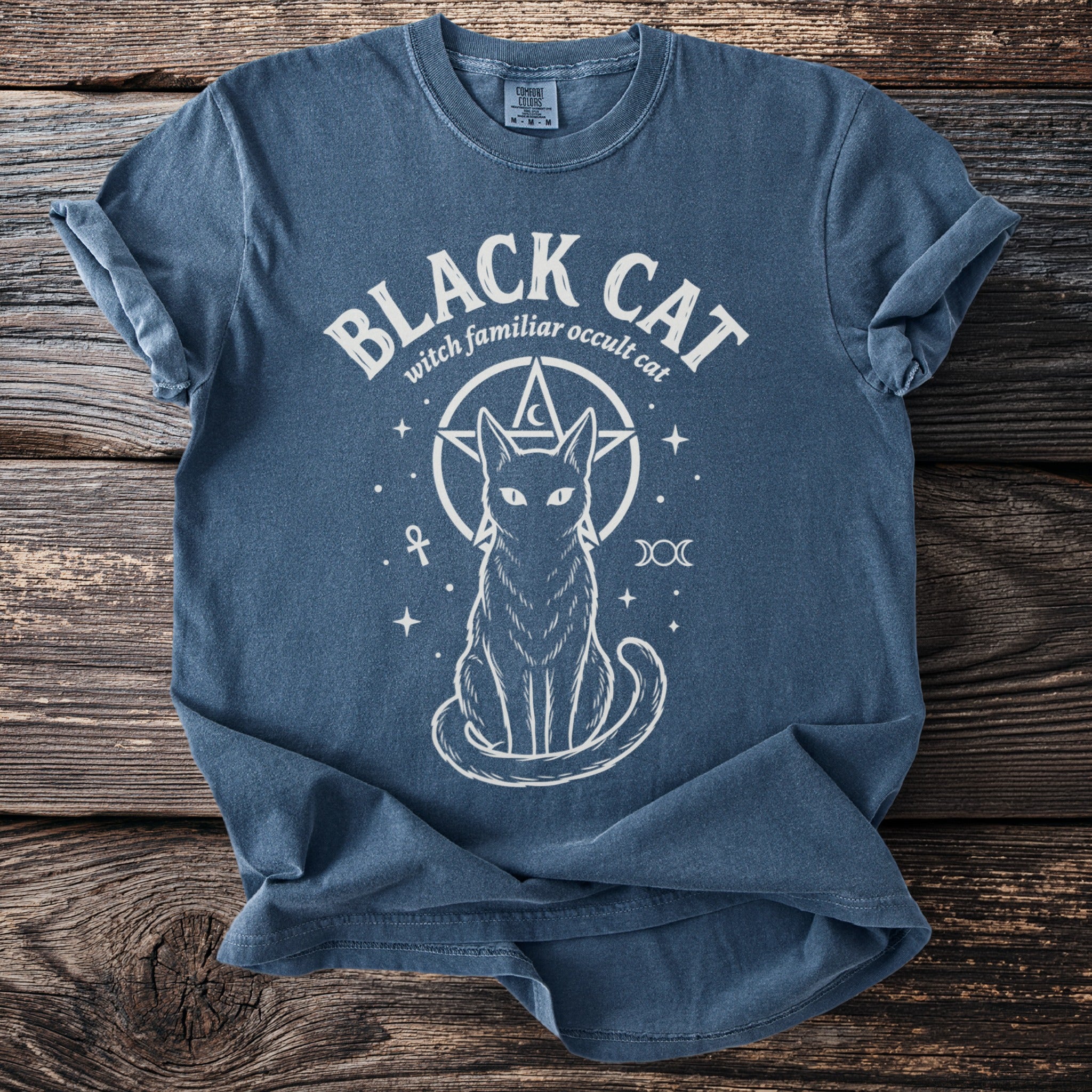 Blue t-shirt with "Black Cat witch familiar occult cat" and a cat symbol.