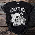 Black t-shirt with "MEMENTO MORI" and skull, hourglass, books, rose, candle design.