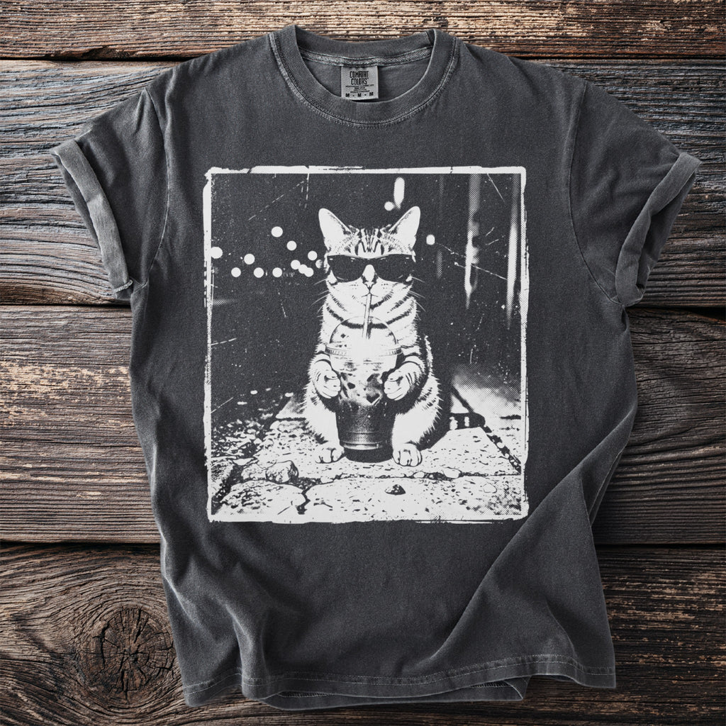 T-shirt with a black and white graphic of a cat wearing sunglasses and drinking from a cup.