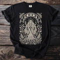 Black t-shirt with a cream-colored celestial woman and moon phase art.