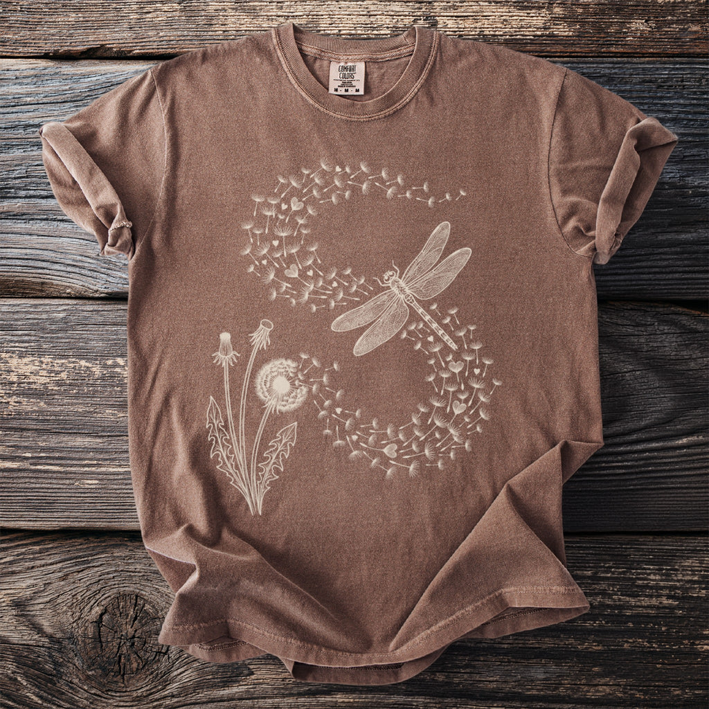 Brown t-shirt with white dragonfly and dandelion graphic print.