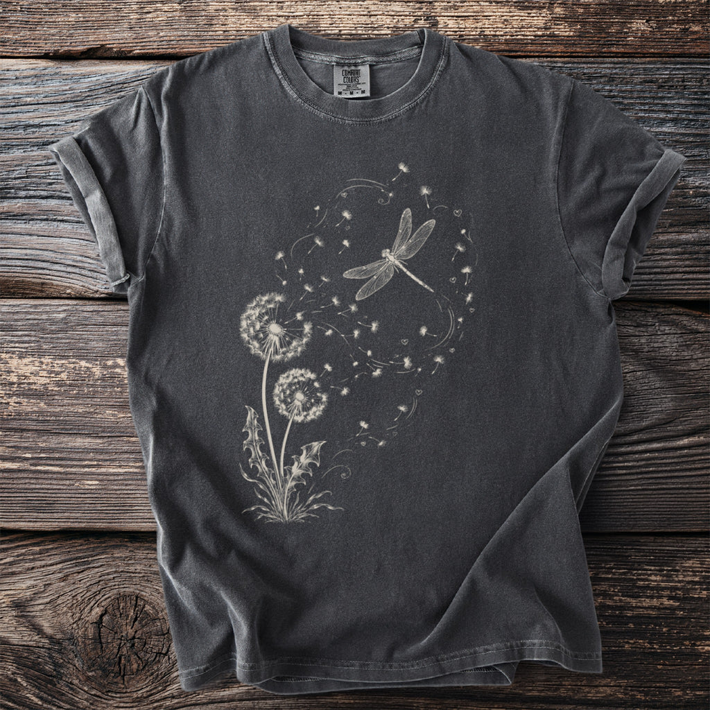 Dark t-shirt with white dragonfly and dandelion seed graphic.