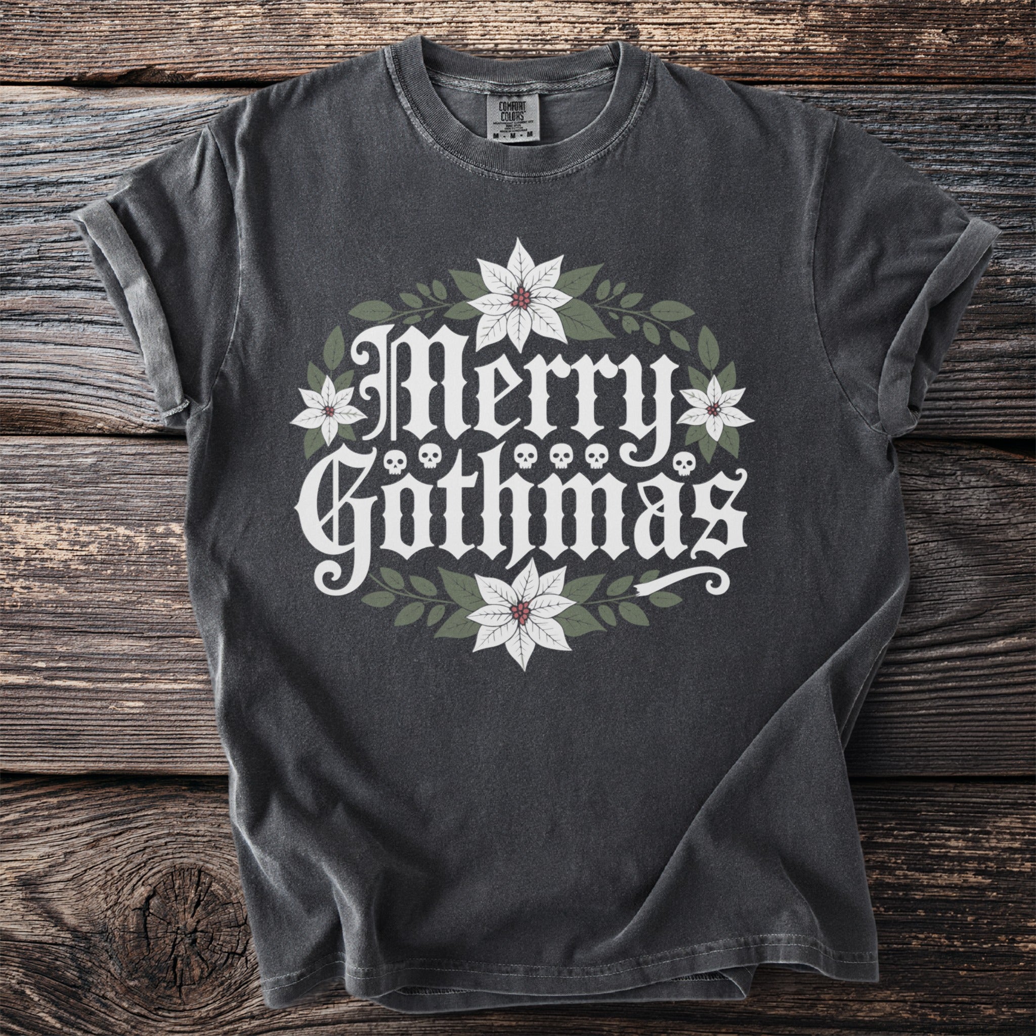 Dark gray t-shirt with "Merry Gothmas" text, skulls, and poinsettias.