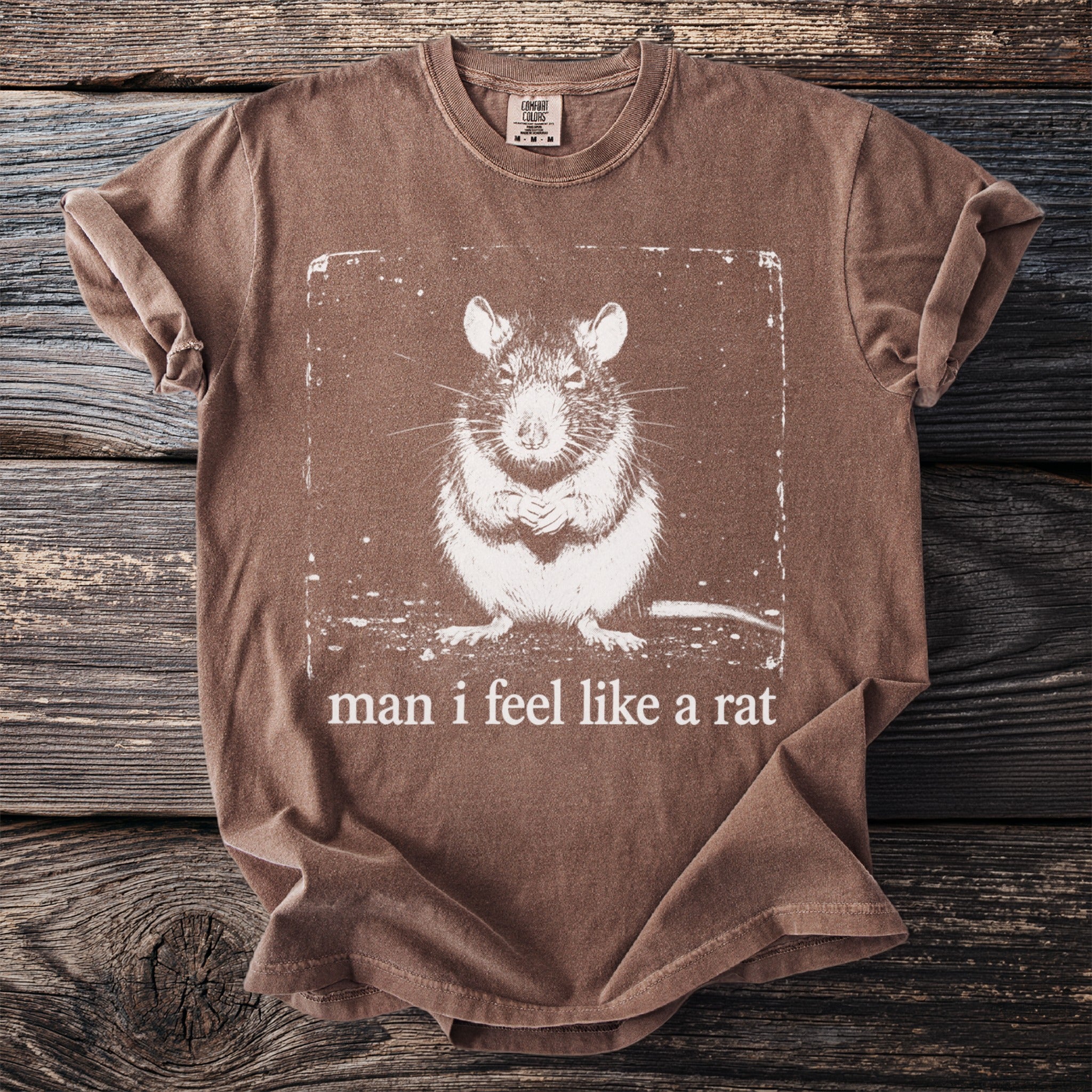 Brown t-shirt with a distressed print of a rat and the text "man i feel like a rat".