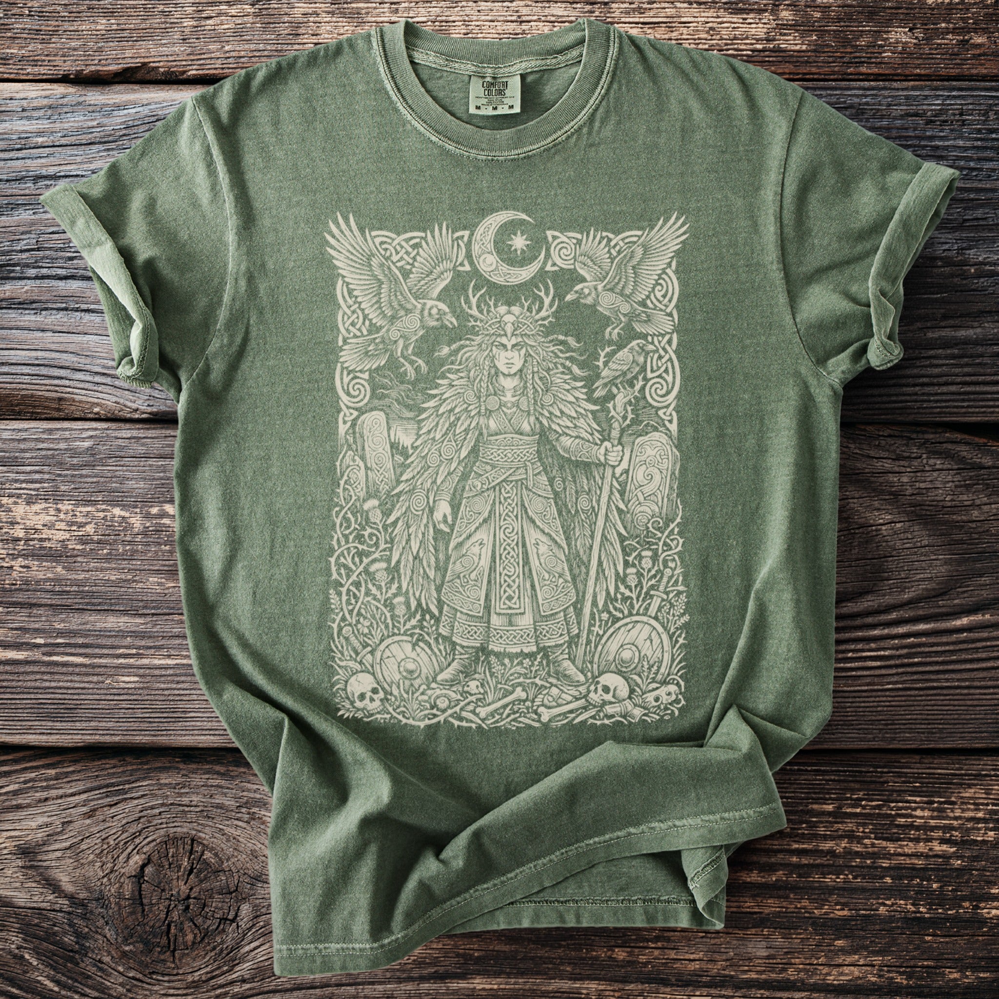 Green t-shirt with a pale graphic of a warrior woman, ravens, and a moon.