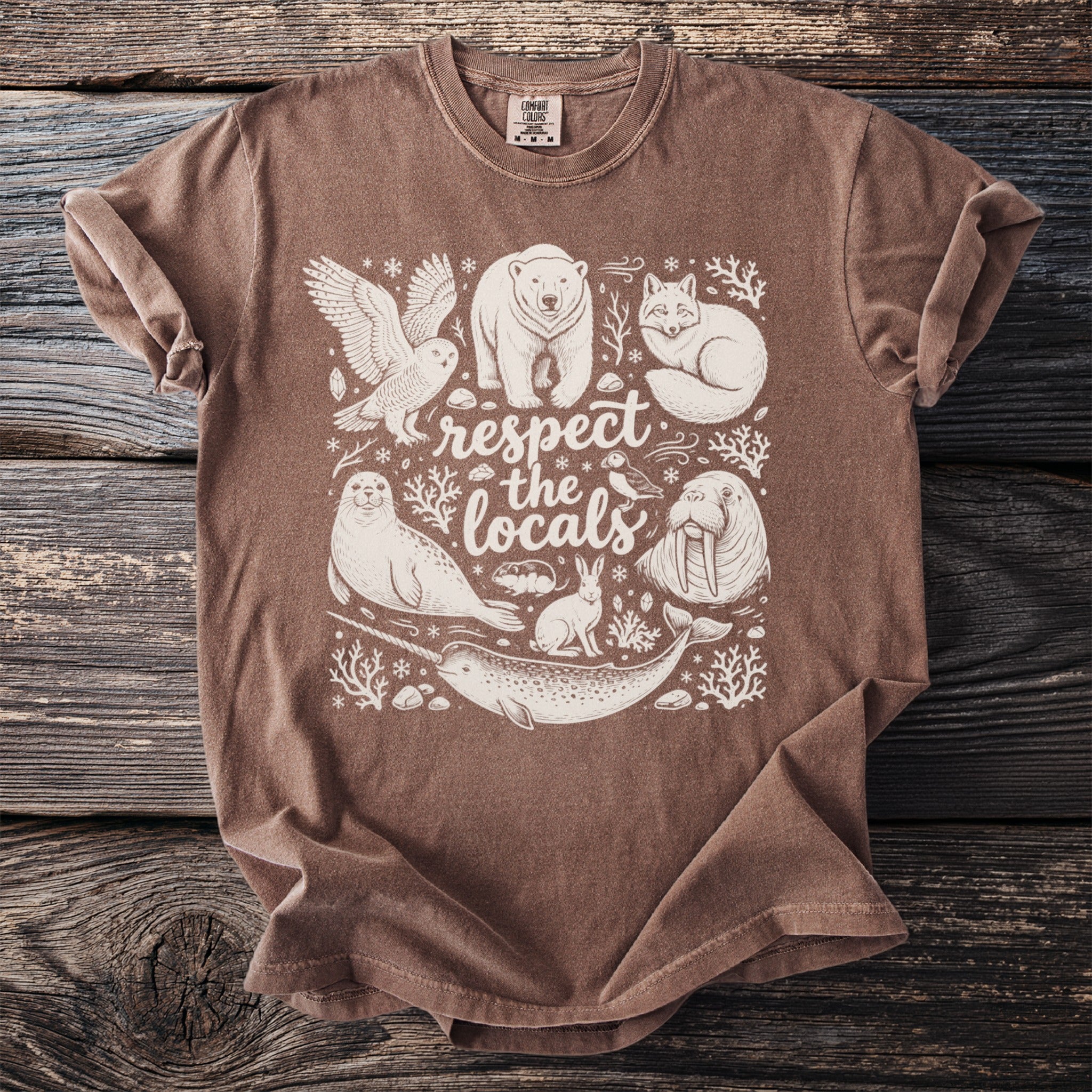 Brown t-shirt featuring an illustration of Arctic animals and the text "respect the locals".