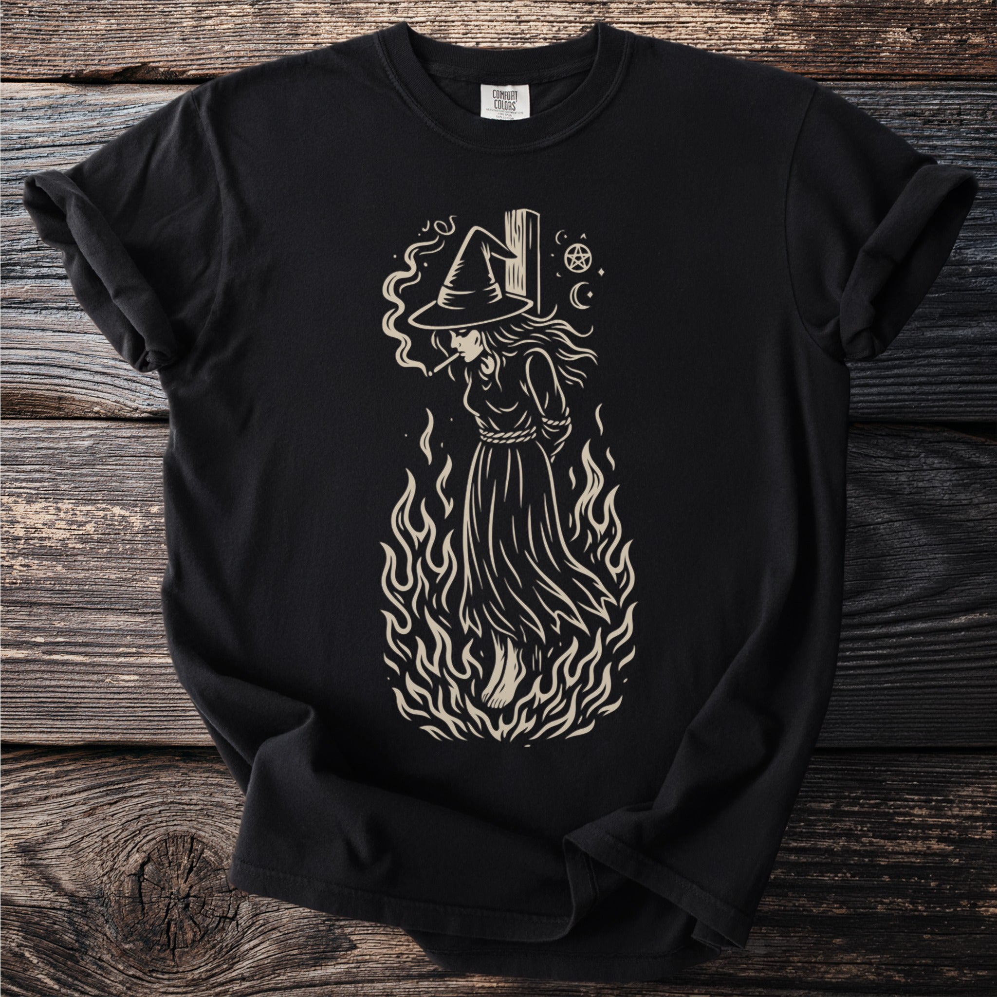 Black t-shirt with a light-colored graphic of a witch in flames smoking.