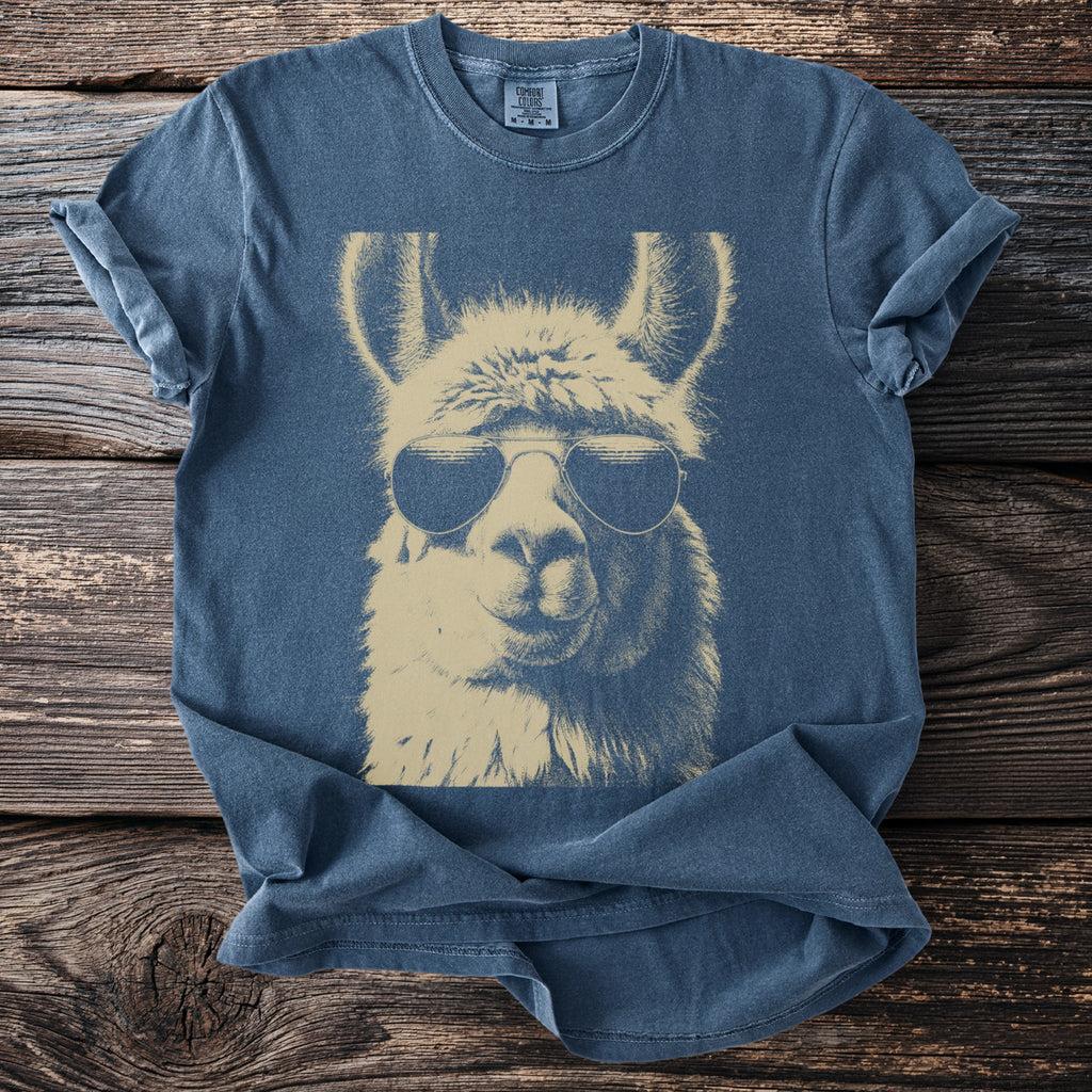 Blue t-shirt with a graphic of a llama wearing aviator sunglasses.