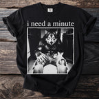 Black t-shirt with "i need a minute" and a werewolf holding a kitten.