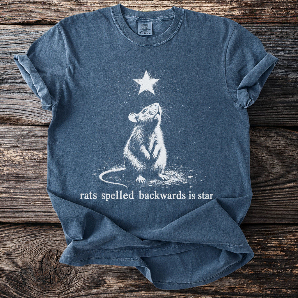 Blue t-shirt with a white graphic of a rat looking up at a star, text reads "rats spelled backwards is star."