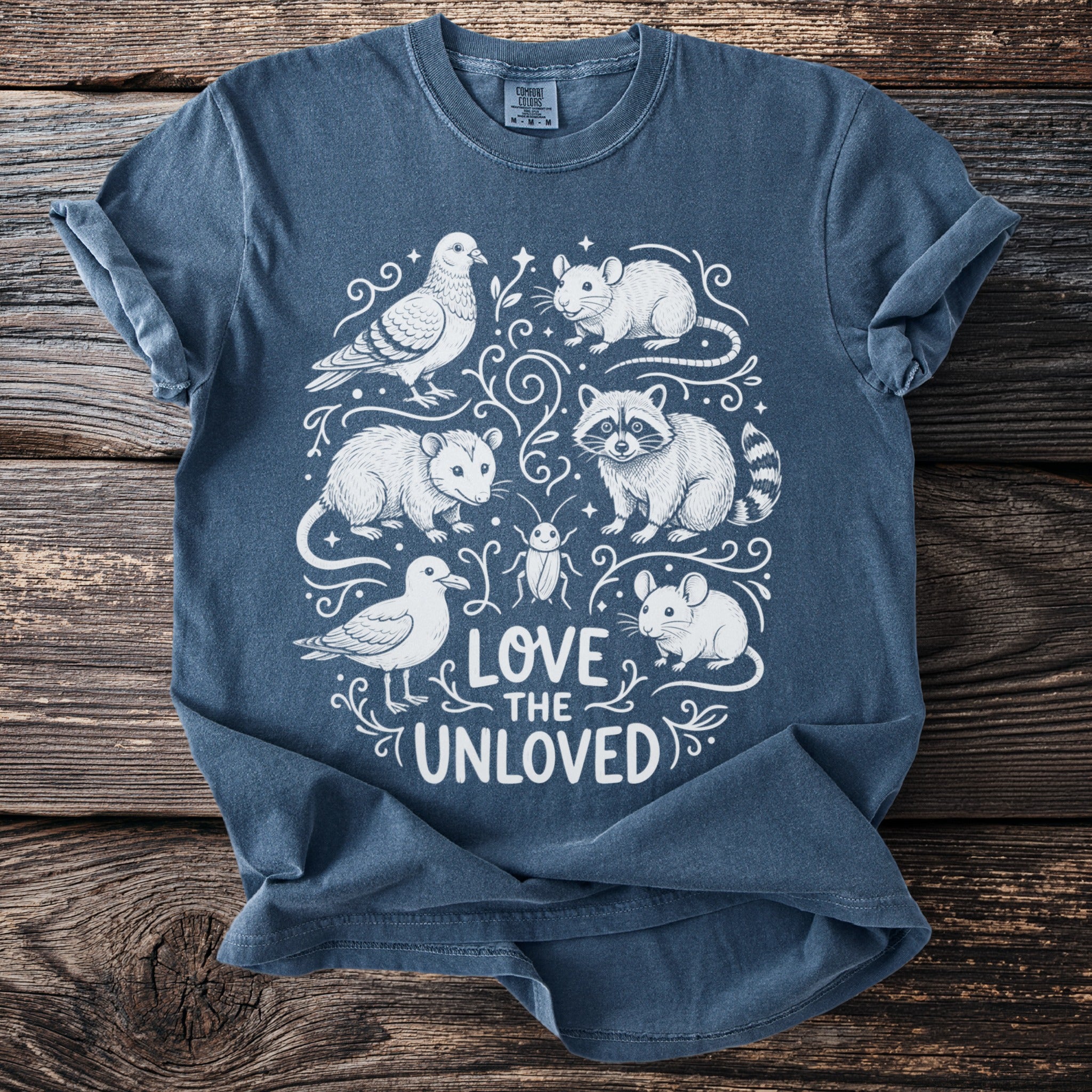 Navy t-shirt with "Love the Unloved" text surrounded by illustrated animals.