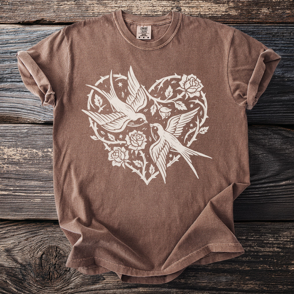 Brown t-shirt with white heart design featuring two swallows and roses.