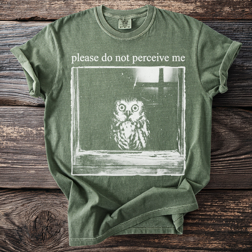 Green t-shirt with a distressed print of an owl and the text "please do not perceive me."