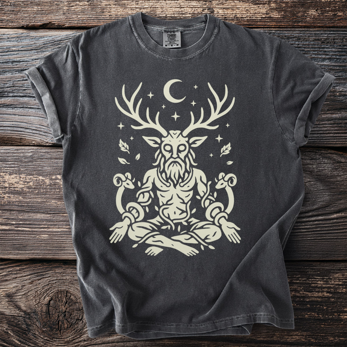 Dark t-shirt with a beige illustration of a seated figure with deer antlers and ram horns.