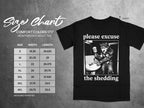 Black t-shirt with "please excuse the shedding" and wolf graphic, with size chart.