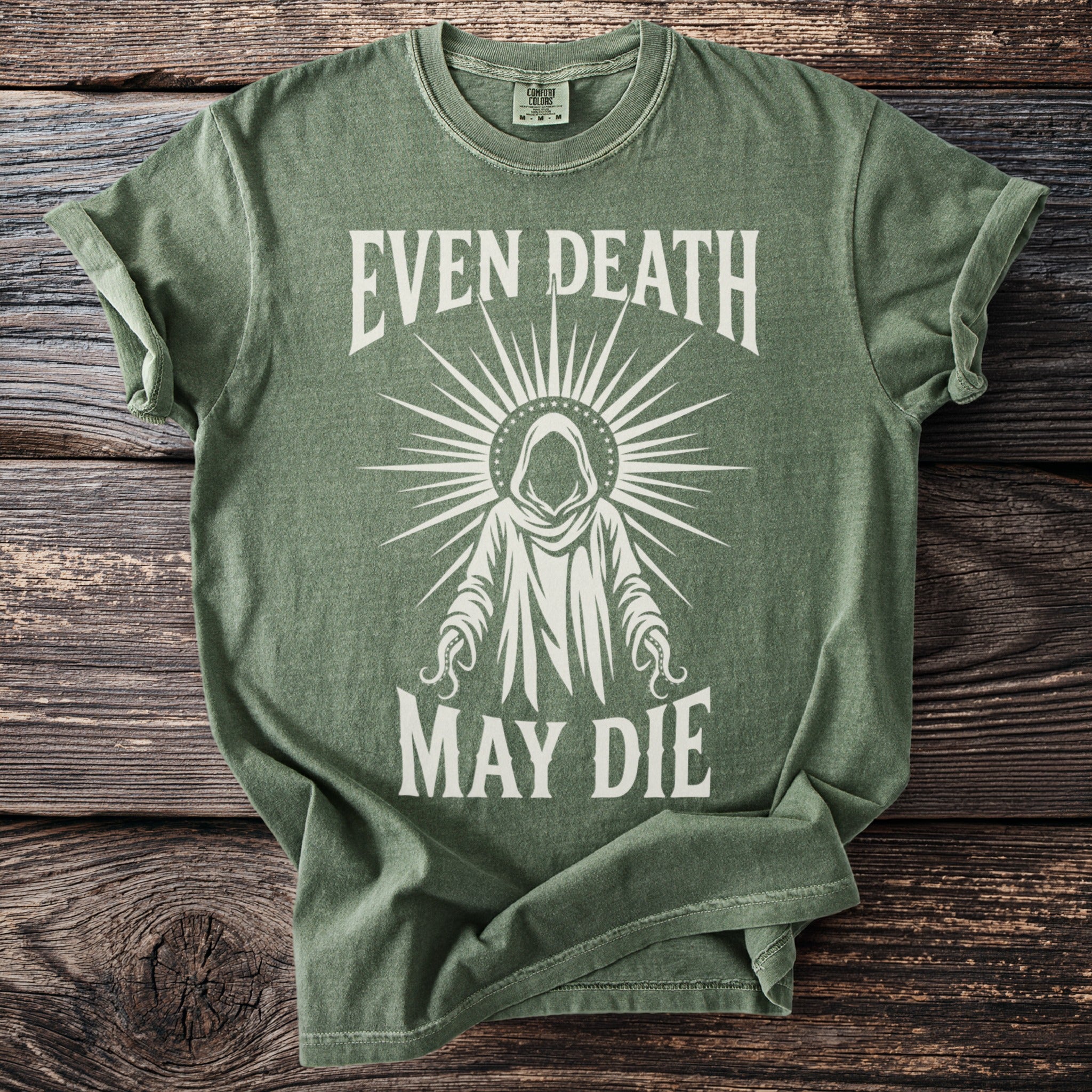 Green t-shirt with white graphic of robed figure and text "EVEN DEATH MAY DIE".